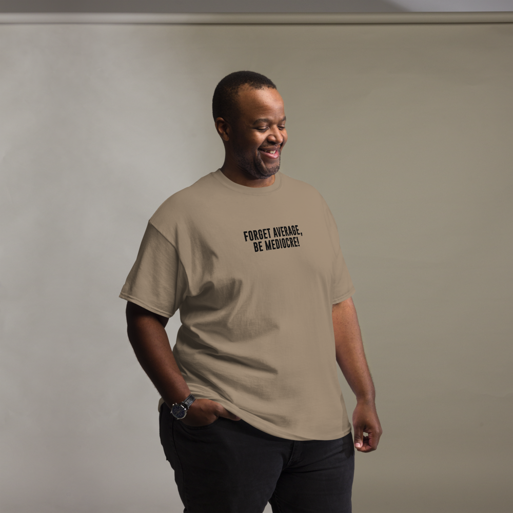 "Forget Average, Be Mediocre!" printed on a brown savana unisex classic tee worn by a male