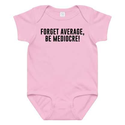 "Forget Average, Be Mediocre!" printed on a pink baby jersey bodysuit laying on a flat surface amongst other clothes