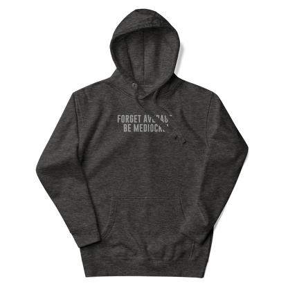 "Forget Average, Be Mediocre!" printed on a charcoal heather unisex hoodie laying on a flat surface with the hood up
