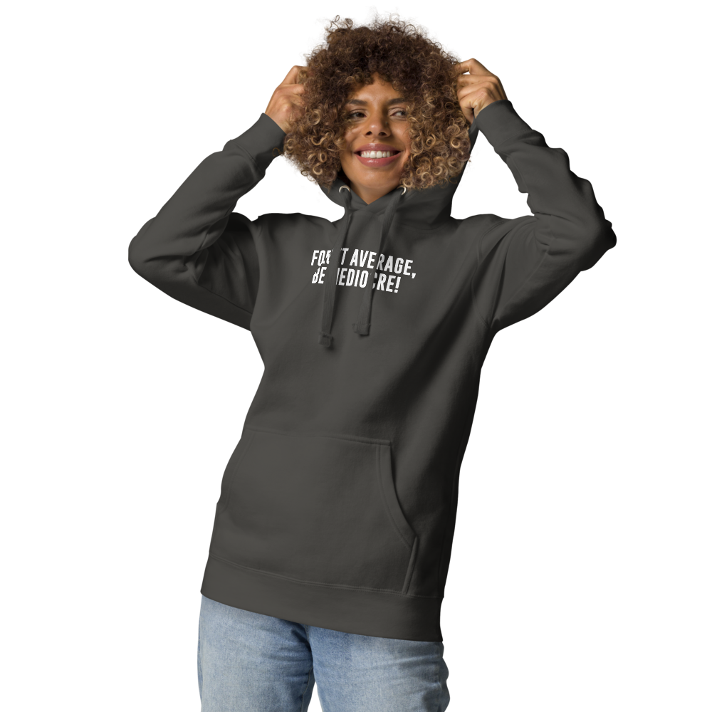 "Forget Average, Be Mediocre!" printed on a vintage black unisex hoodie worn by a female