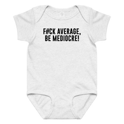 "F#Ck Average, Be Mediocre!" printed on a ash baby jersey bodysuit laying on a flat surface amongst other clothes