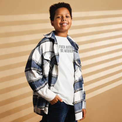 "Fuck Average, Be Mediocre!" printed on a white youth classic tee worn by a male also wearing a jacket