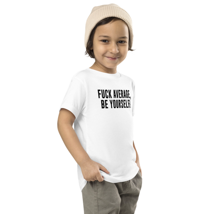 "Fuck Average, Be Yourself!" printed on a white toddler short sleeve tee worn by a male who is also wearing a knit cap