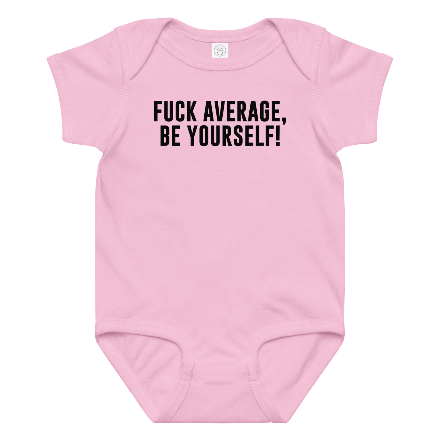 "Fuck Average, Be Yourself!" printed on a pink baby jersey bodysuit laying on a flat surface amongst other clothes