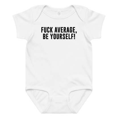 "Fuck Average, Be Yourself!" printed on a white baby jersey bodysuit laying on a flat surface amongst other clothes