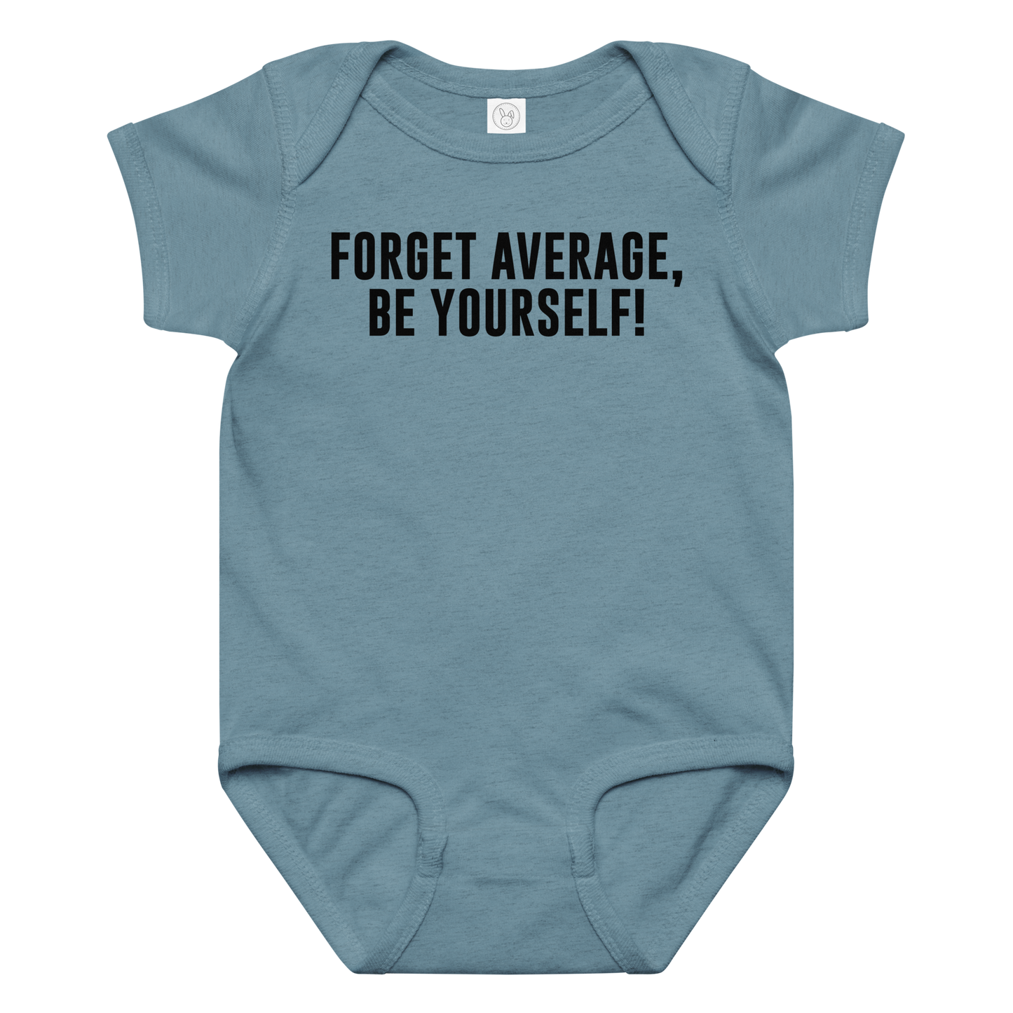 "Forget Average, Be Yourself!" printed on a vintage indigo baby jersey bodysuit laying on a flat surface amongst other clothes