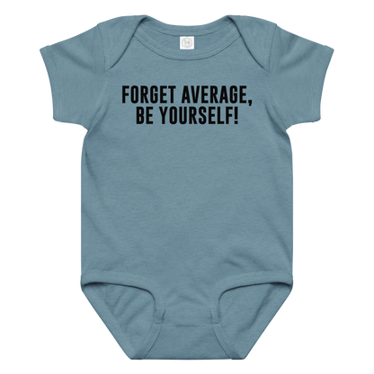 "Forget Average, Be Yourself!" printed on a vintage indigo baby jersey bodysuit laying on a flat surface amongst other clothes
