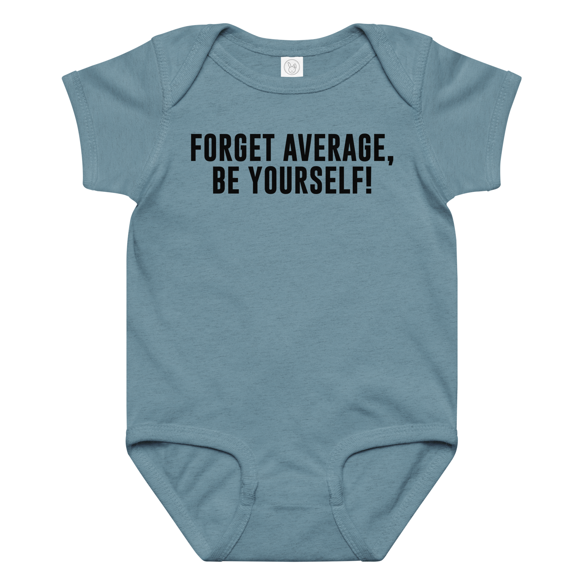 "Forget Average, Be Yourself!" printed on a vintage indigo baby jersey bodysuit laying on a flat surface amongst other clothes