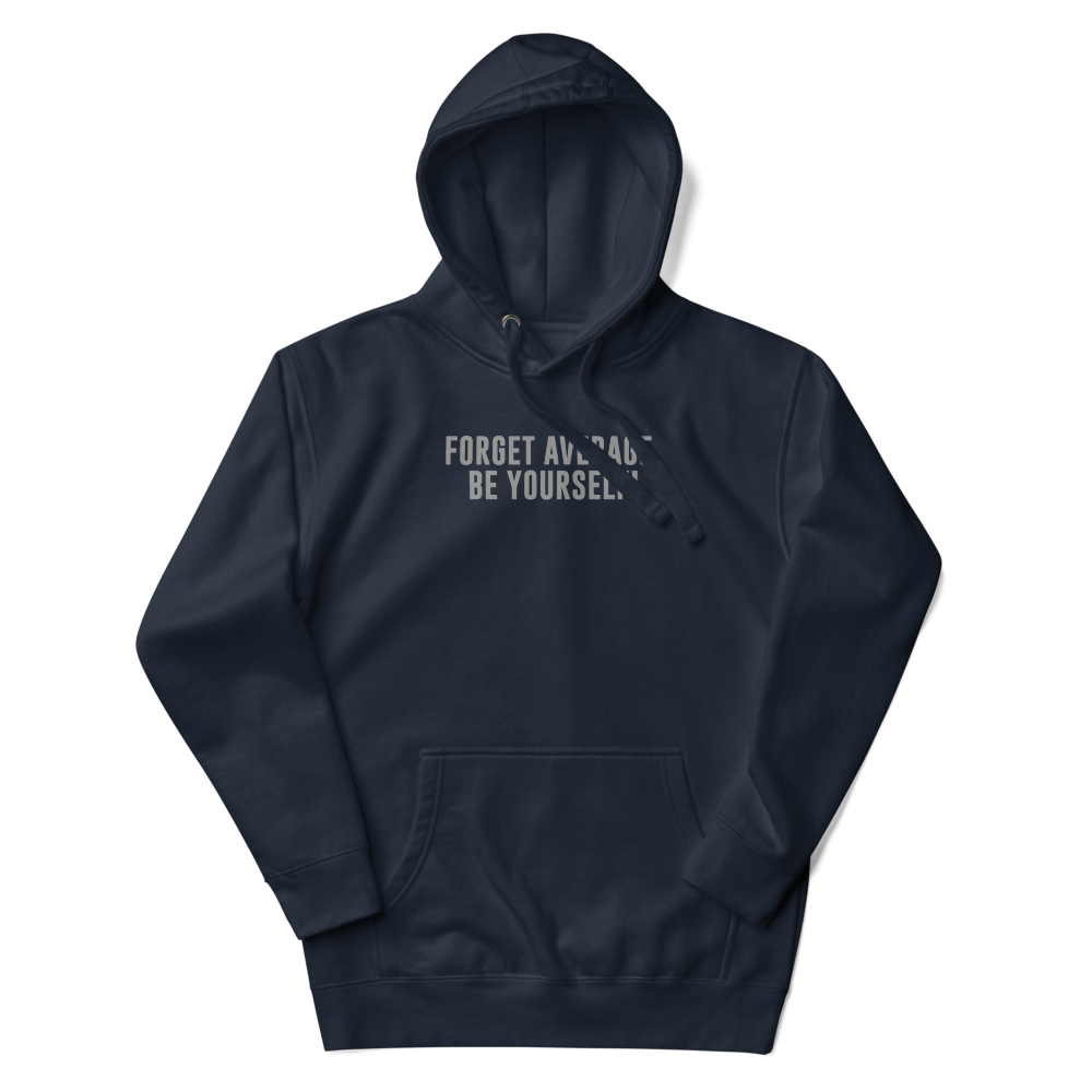 "Forget Average, Be Yourself!" printed on a navy blazer unisex hoodie laying on a flat surface with the hood up