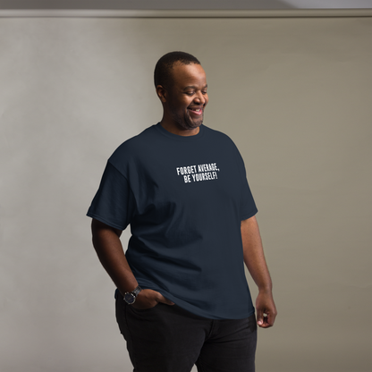 "Forget Average, Be Yourself!" printed on a navy unisex classic tee worn by a male