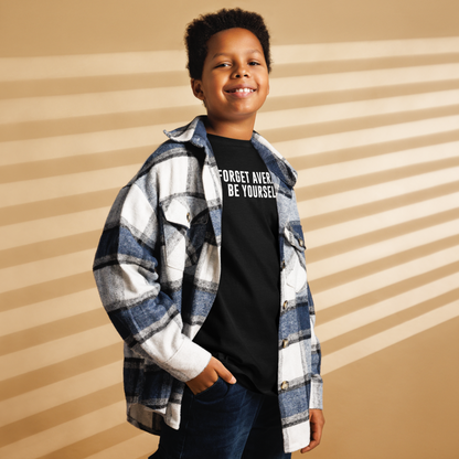 "Forget Average, Be Yourself!" printed on a black youth classic tee worn by a male also wearing a jacket