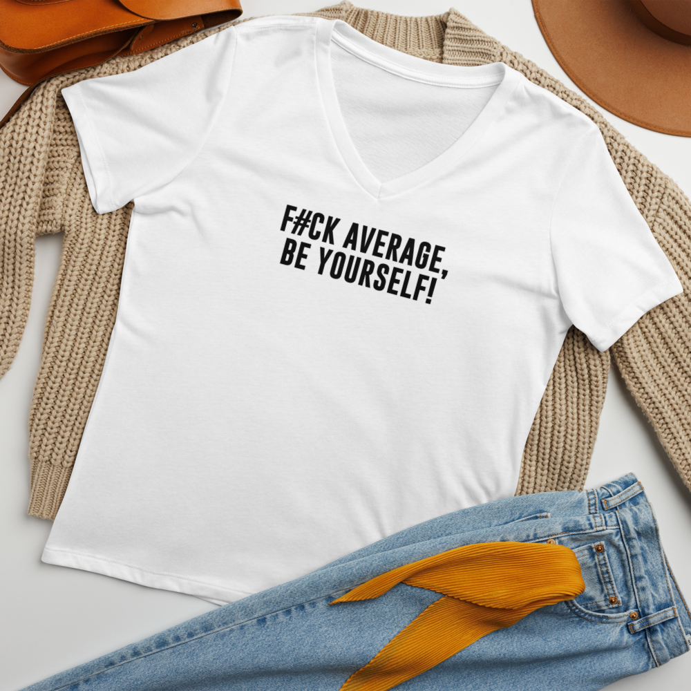 "F#Ck Average, Be Yourself!" printed on a solid white blend women's relaxed v-neck t-shirt laying on a flat surface amongst other clothes