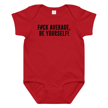 "F#Ck Average, Be Yourself!" printed on a red baby jersey bodysuit laying on a flat surface amongst other clothes