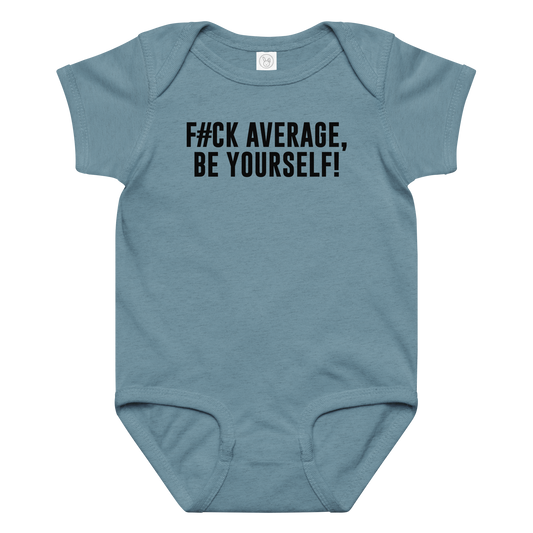 "F#Ck Average, Be Yourself!" printed on a vintage indigo baby jersey bodysuit laying on a flat surface amongst other clothes