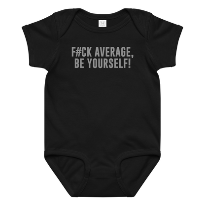 "F#Ck Average, Be Yourself!" printed on a black baby jersey bodysuit laying on a flat surface amongst other clothes