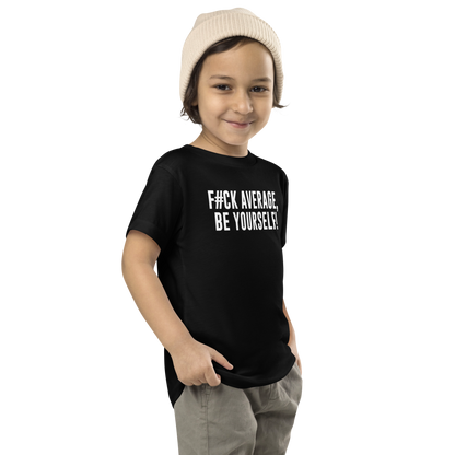 "F#Ck Average, Be Yourself!" printed on a black toddler short sleeve tee worn by a male who is also wearing a knit cap