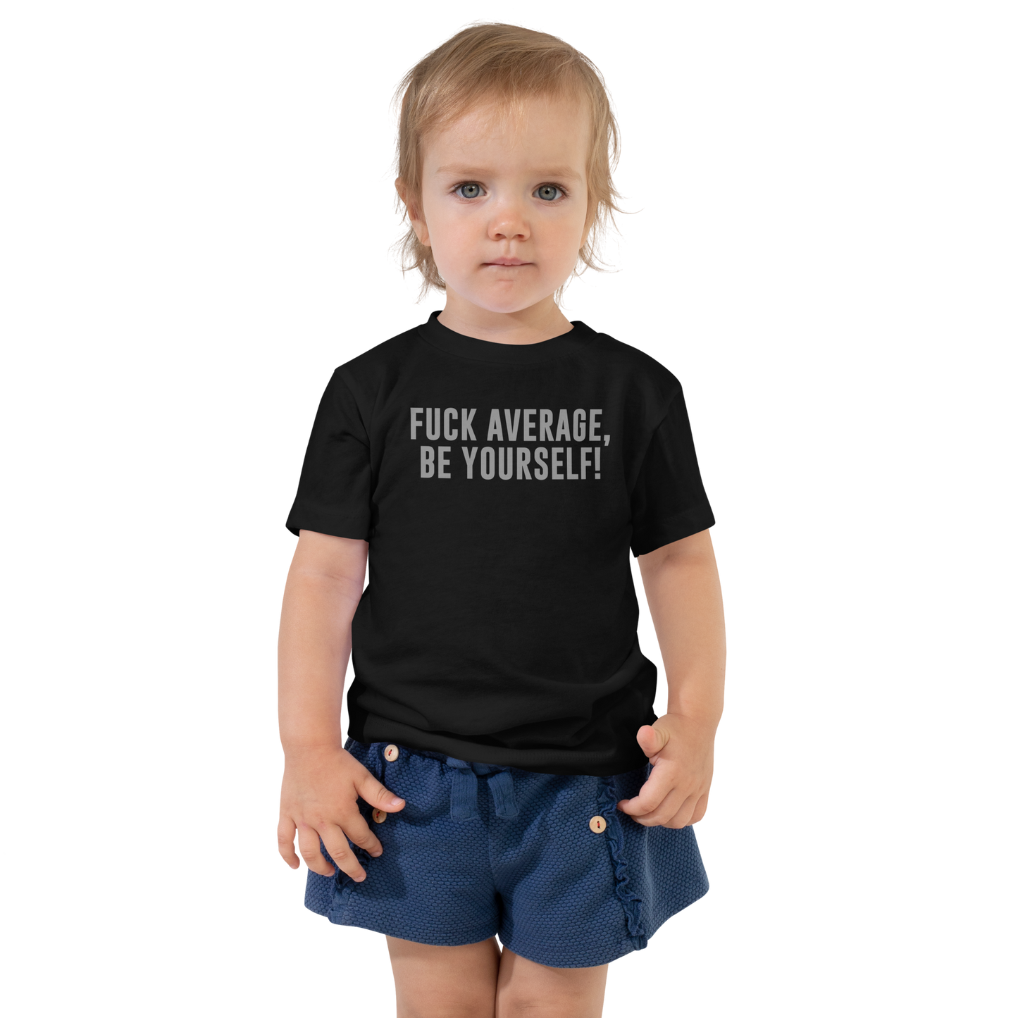 "Fuck Average, Be Yourself!" printed on a black toddler short sleeve tee worn by a female