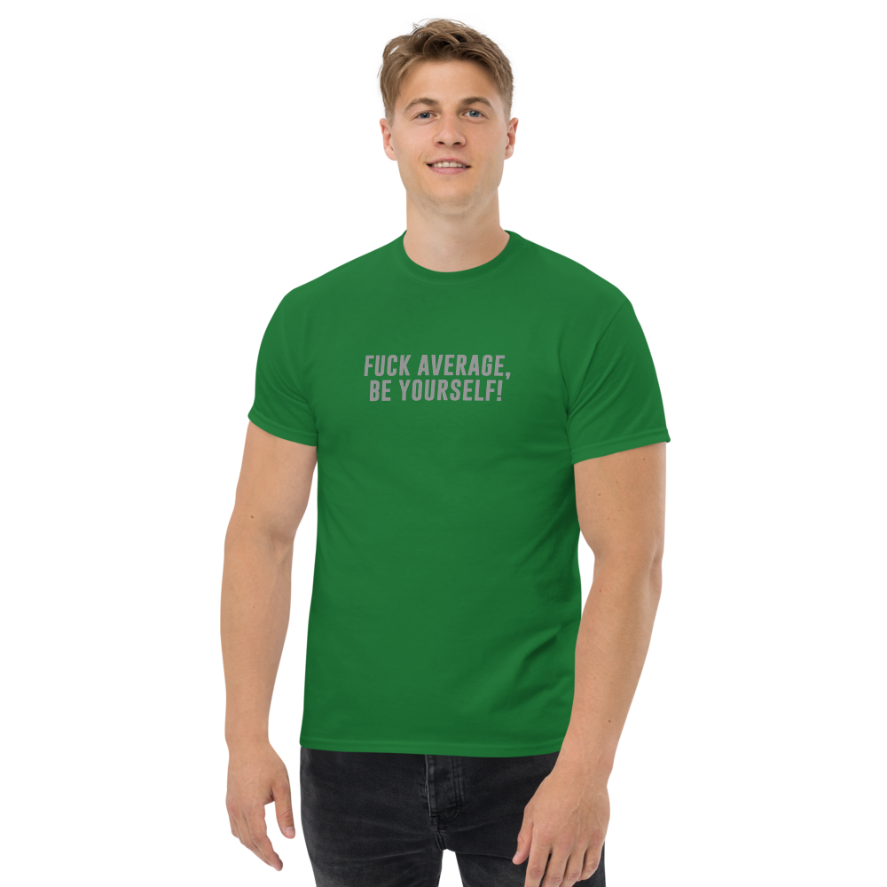 "Fuck Average, Be Yourself!" printed on a turf green unisex classic tee worn by a male