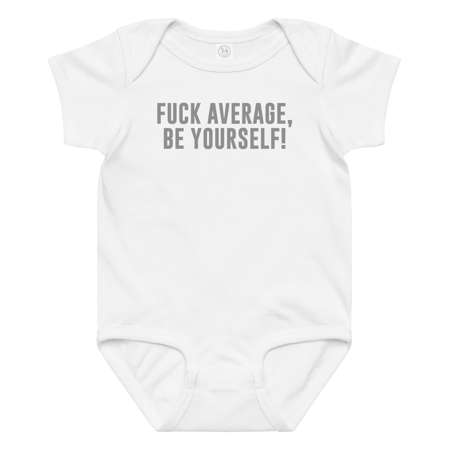 "Fuck Average, Be Yourself!" printed on a white baby jersey bodysuit laying on a flat surface amongst other clothes