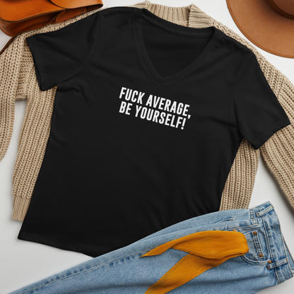 "Fuck Average, Be Yourself!" printed on a solid black blend women's relaxed v-neck t-shirt laying on a flat surface amongst other clothes