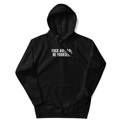 "Fuck Average, Be Yourself!" printed on a black unisex hoodie laying on a flat surface with the hood up