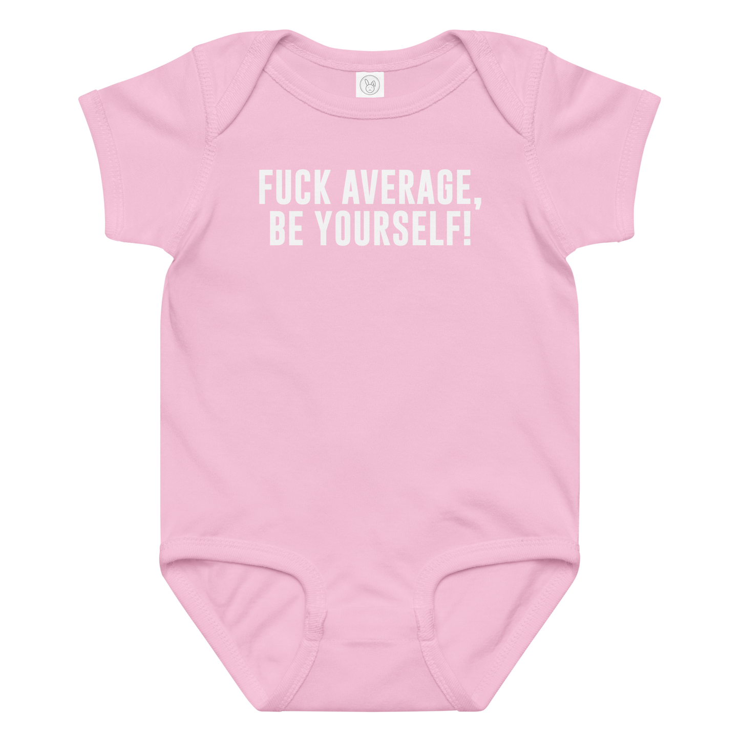 "Fuck Average, Be Yourself!" printed on a pink baby jersey bodysuit laying on a flat surface amongst other clothes