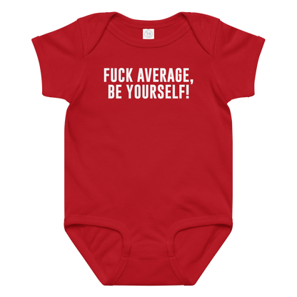 "Fuck Average, Be Yourself!" printed on a red baby jersey bodysuit laying on a flat surface amongst other clothes