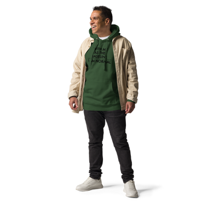 "With me as the baseline, I am normal" printed on a forest green unisex hoodie worn by a male with a jacket on top