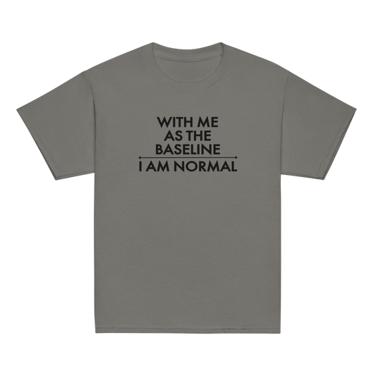 "With me as the baseline, I am normal" printed on a charcoal youth classic tee laying on a flat surface