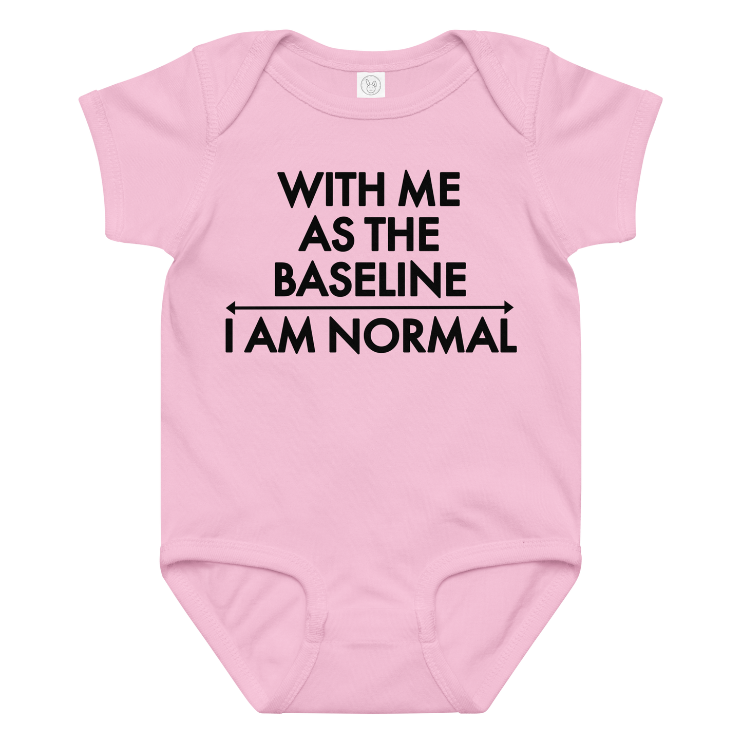 "With me as the baseline, I am normal" printed on a pink baby jersey bodysuit laying on a flat surface amongst other clothes