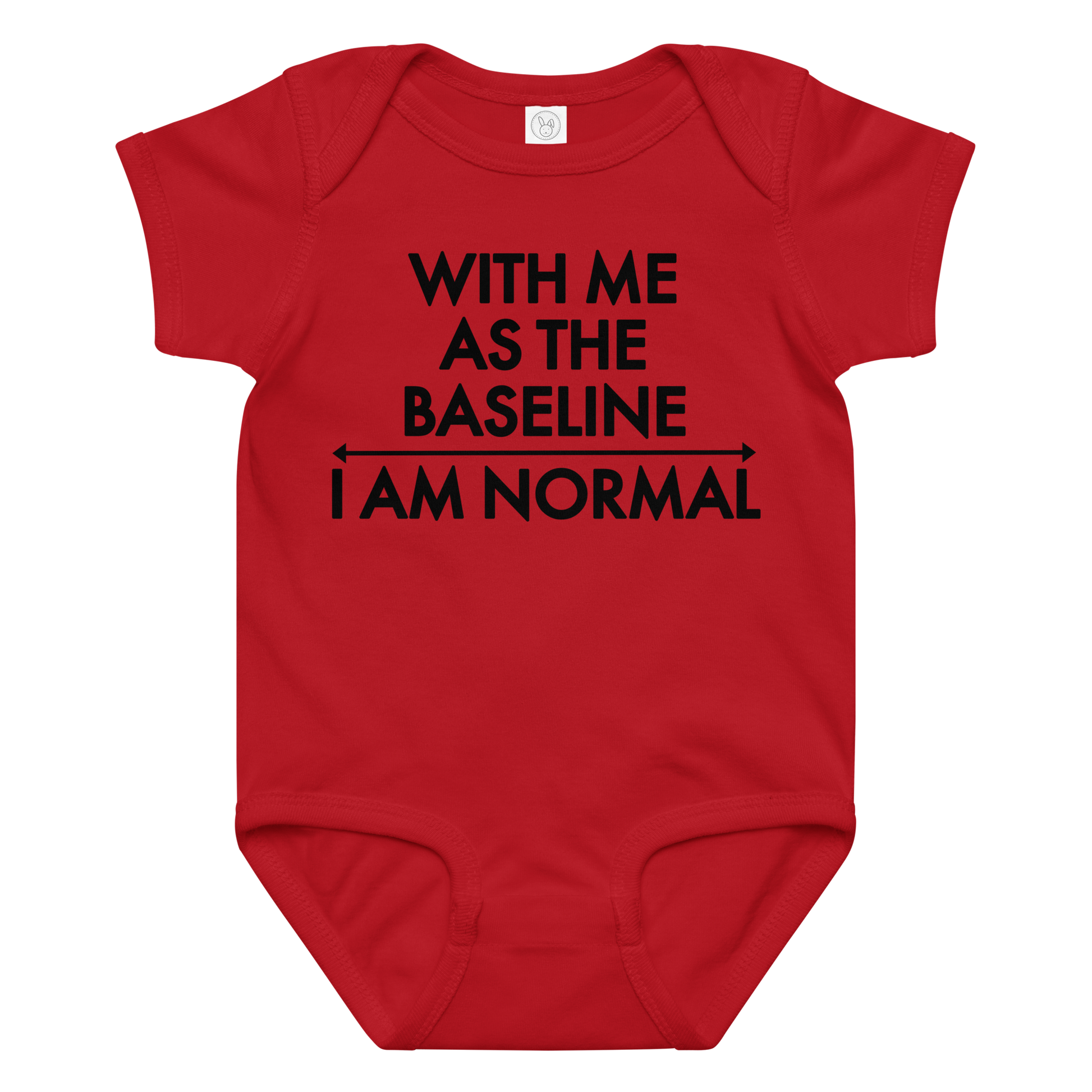 "With me as the baseline, I am normal" printed on a red baby jersey bodysuit laying on a flat surface amongst other clothes