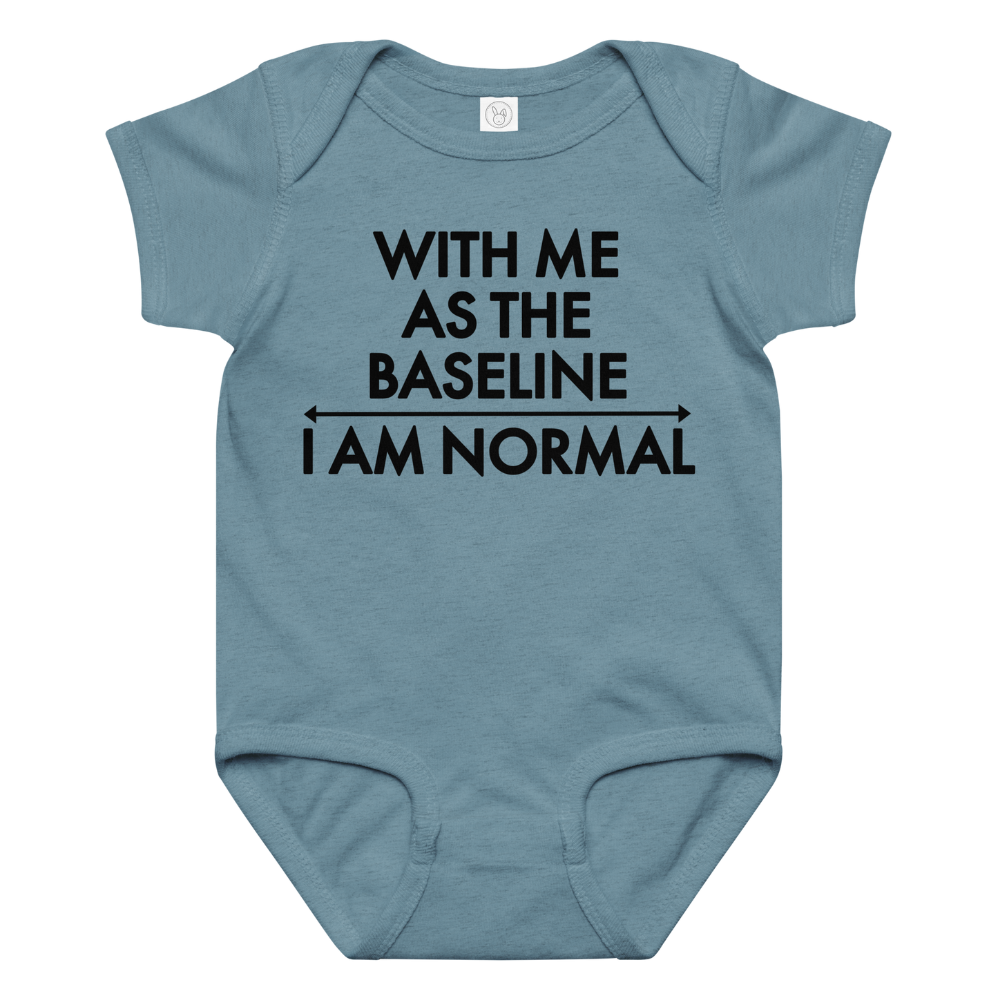 "With me as the baseline, I am normal" printed on a vintage indigo baby jersey bodysuit laying on a flat surface amongst other clothes