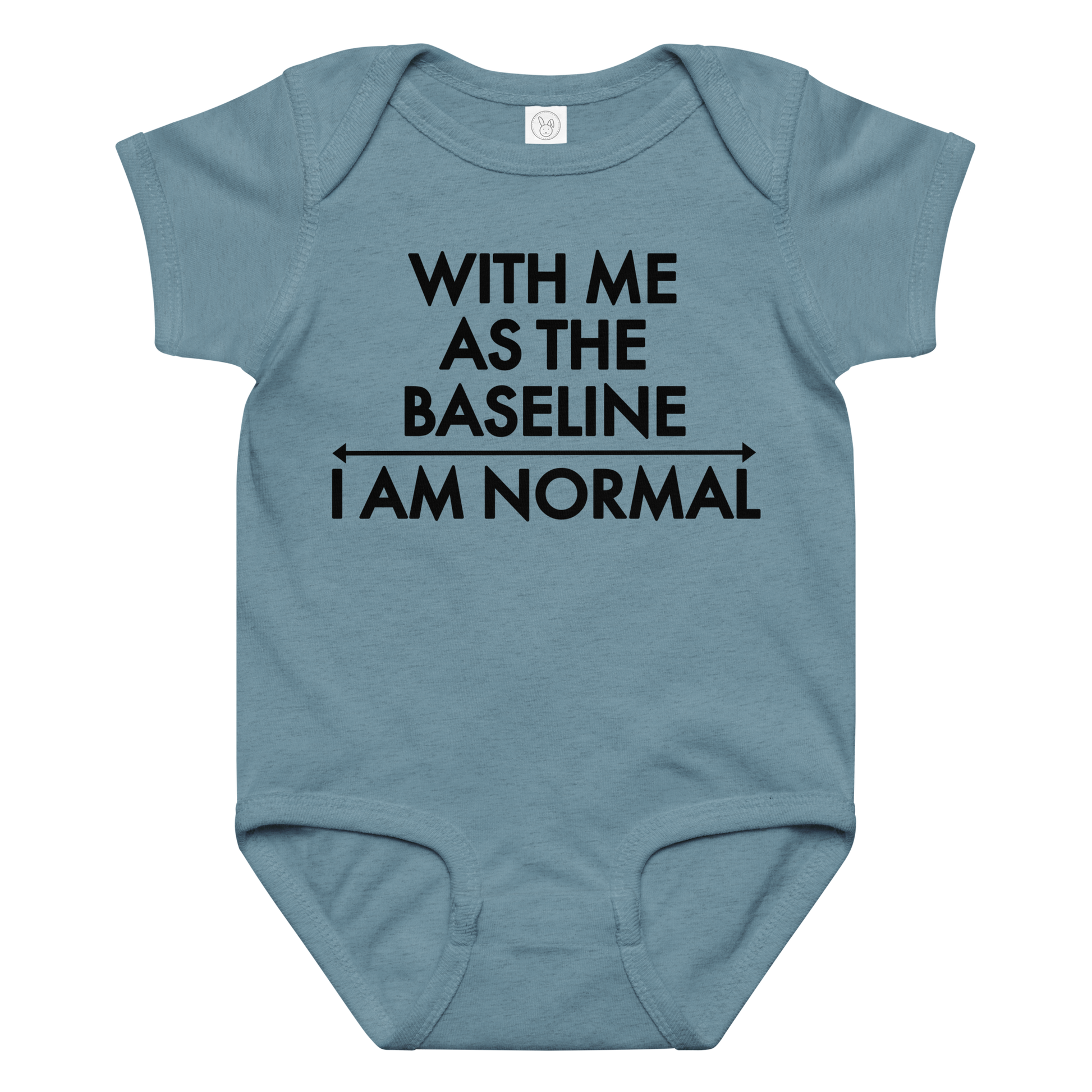 "With me as the baseline, I am normal" printed on a vintage indigo baby jersey bodysuit laying on a flat surface amongst other clothes
