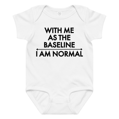 "With me as the baseline, I am normal" printed on a white baby jersey bodysuit laying on a flat surface amongst other clothes