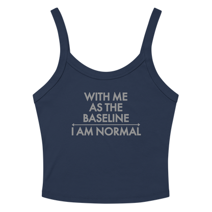 "With me as the baseline, I am normal" printed on a solid navy blend women's micro-rib tanktop laying on a flat surface amongst sunglasses and shorts