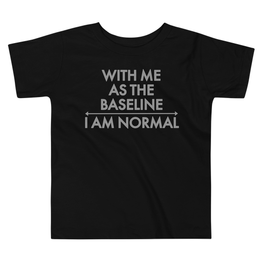 "With me as the baseline, I am normal" printed on a black toddler short sleeve tee laying on a flat surface