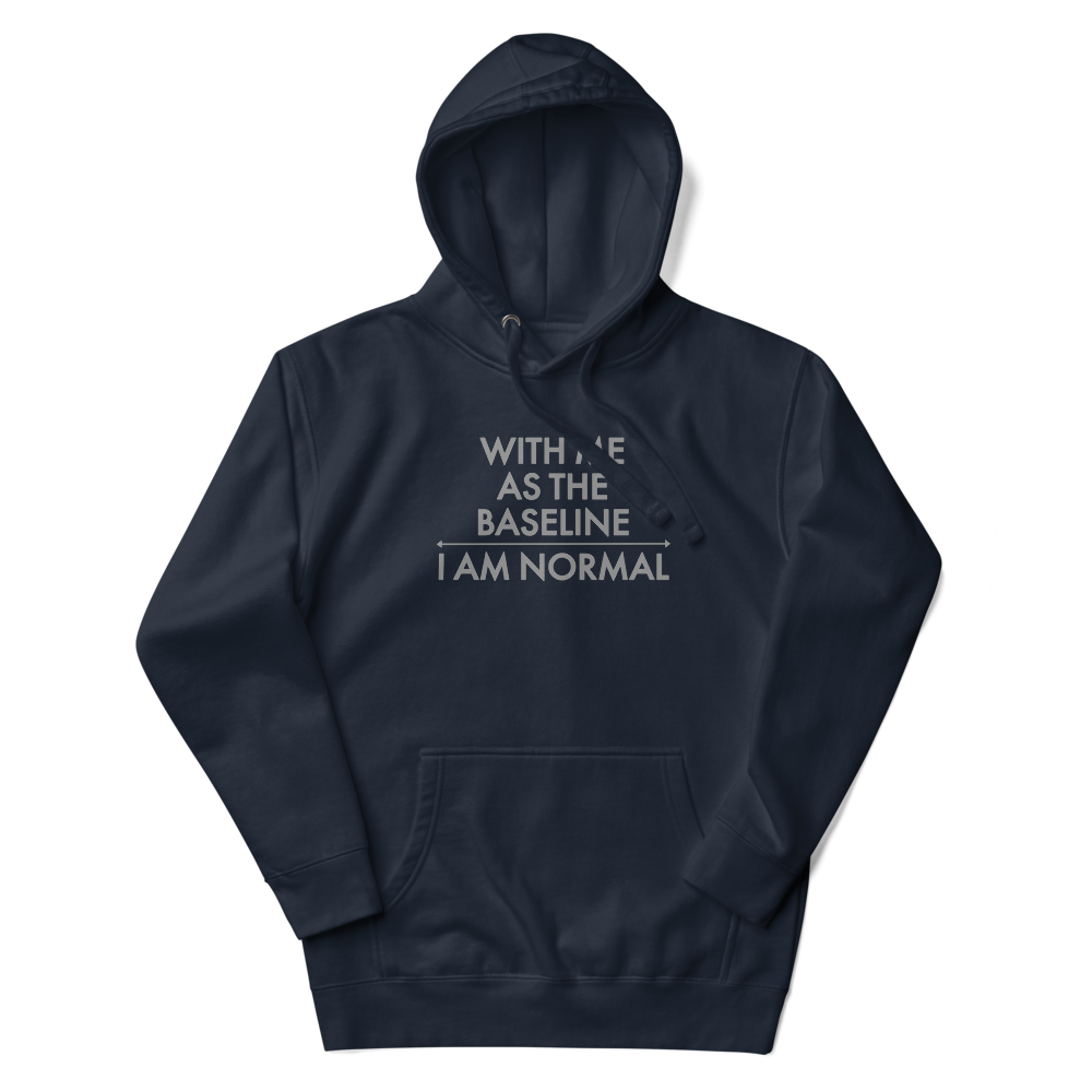 "With me as the baseline, I am normal" printed on a navy blazer unisex hoodie laying on a flat surface with the hood up