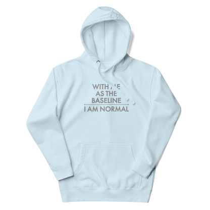 "With me as the baseline, I am normal" printed on a sky blue unisex hoodie laying on a flat surface with the hood up