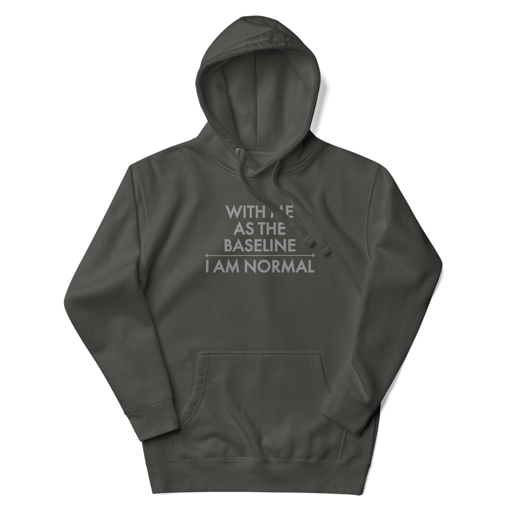 "With me as the baseline, I am normal" printed on a vintage black unisex hoodie laying on a flat surface with the hood up