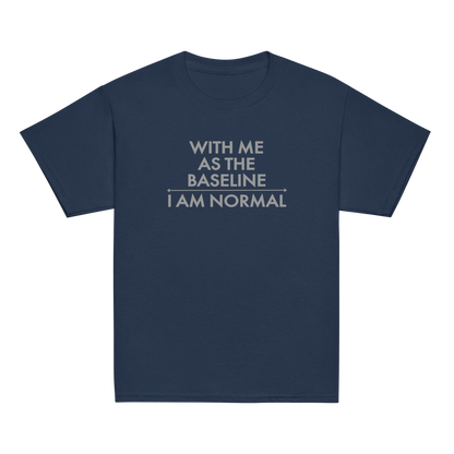 "With me as the baseline, I am normal" printed on a navy youth classic tee laying on a flat surface