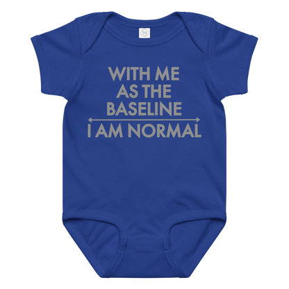 "With me as the baseline, I am normal" printed on a royal baby jersey bodysuit laying on a flat surface amongst other clothes