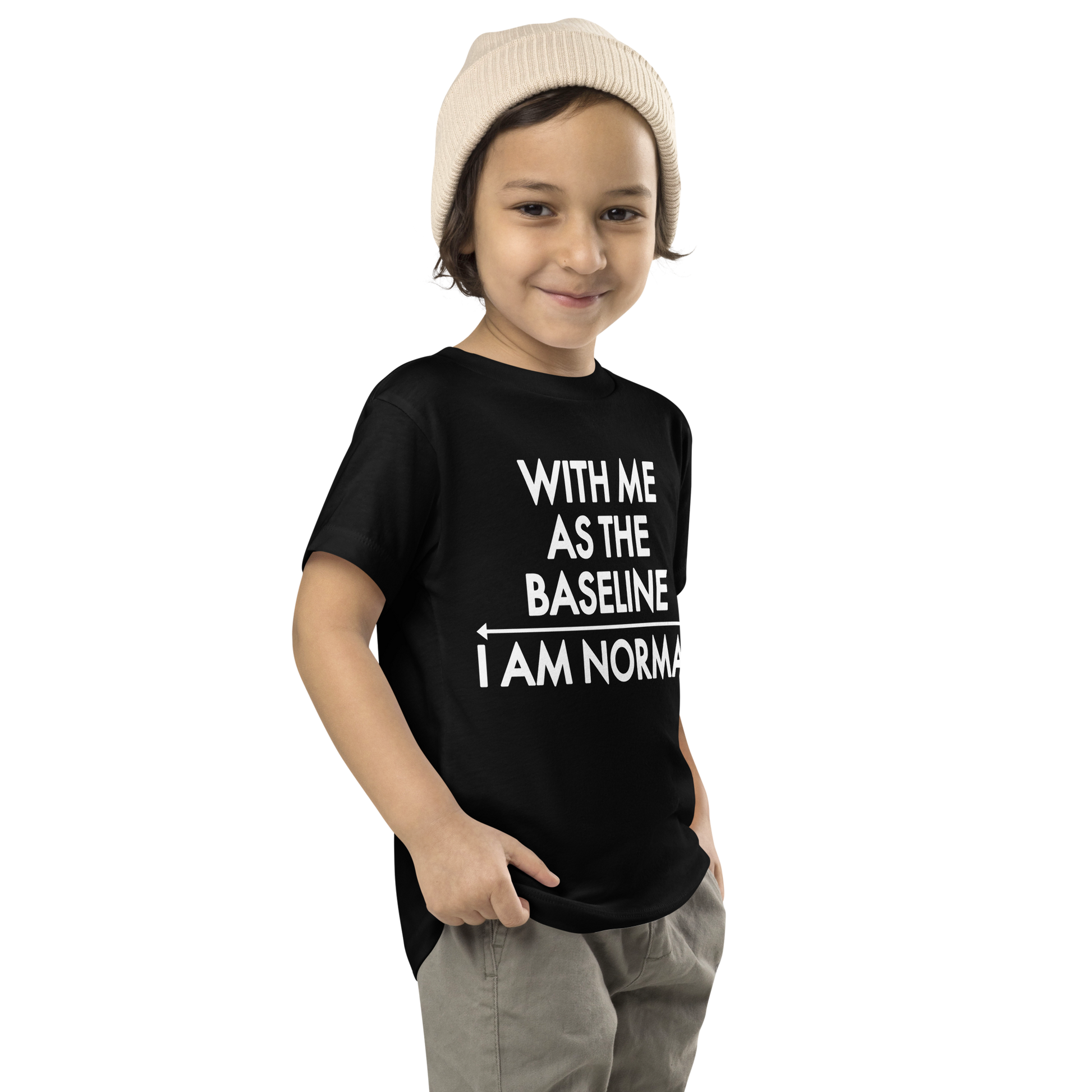 "With me as the baseline, I am normal" printed on a black toddler short sleeve tee worn by a male who is also wearing a knit cap