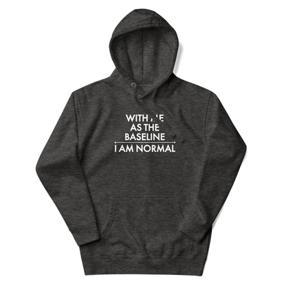 "With me as the baseline, I am normal" printed on a charcoal heather unisex hoodie laying on a flat surface with the hood up