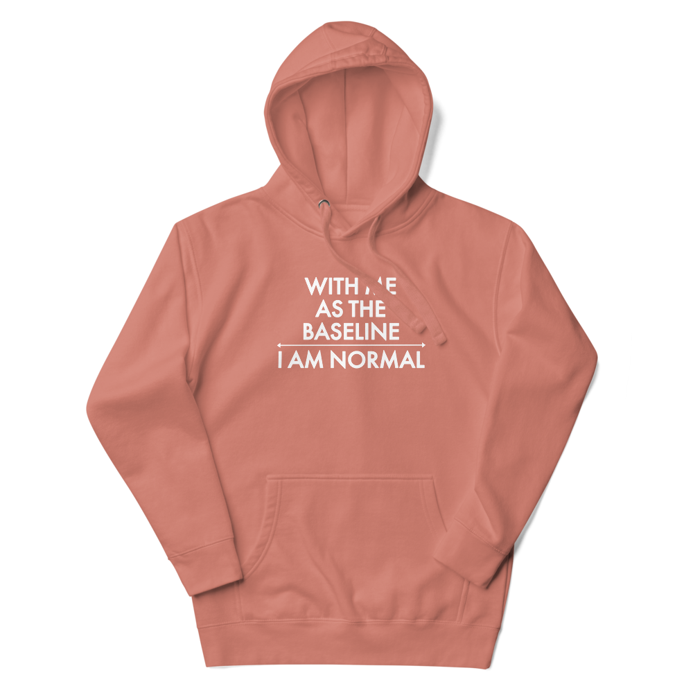 "With me as the baseline, I am normal" printed on a dusty rose unisex hoodie laying on a flat surface with the hood up