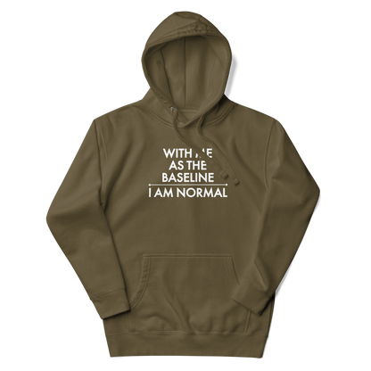 "With me as the baseline, I am normal" printed on a military green unisex hoodie laying on a flat surface with the hood up