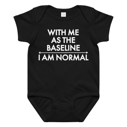 "With me as the baseline, I am normal" printed on a black baby jersey bodysuit laying on a flat surface amongst other clothes