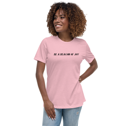 "Be a beacon of joy" printed on a pink women's relaxed t-shirt worn by a female