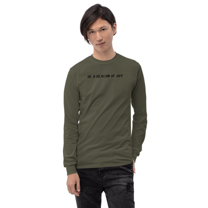 "Be a beacon of joy" printed on a military green men's long sleeve shirt worn by a male