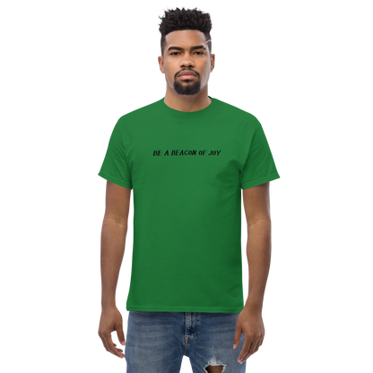 "Be a beacon of joy" printed on a turf green unisex classic tee worn by a male
