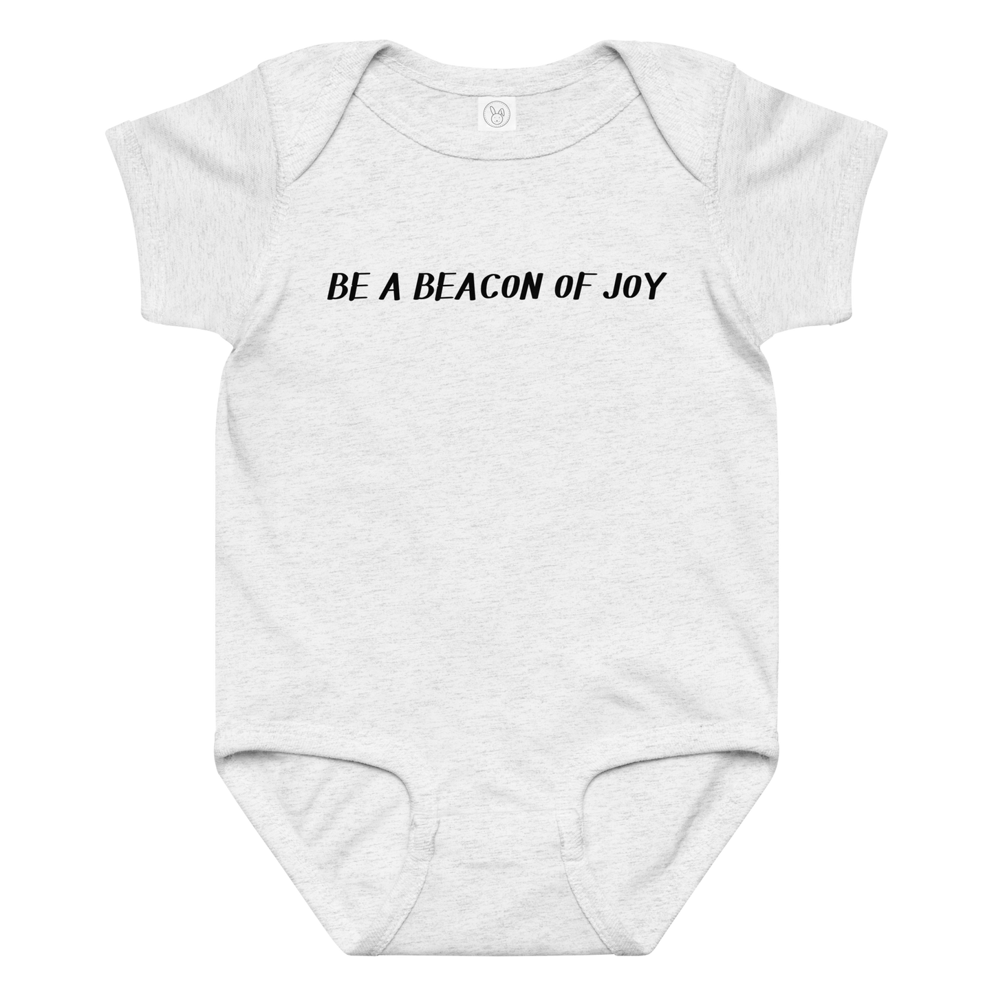 "Be a beacon of joy" printed on a ash baby jersey bodysuit laying on a flat surface amongst other clothes